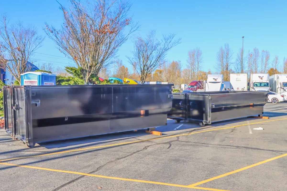 Professional dumpster rental service with roll-off container on residential driveway in Ocean Shores